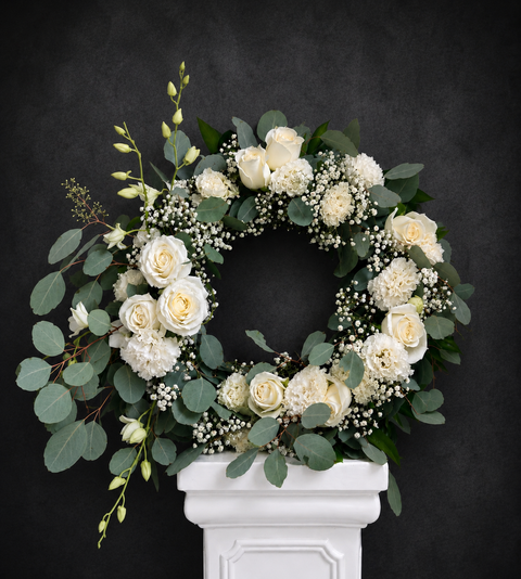 White Funeral Wreath with premium roses, lisianthus, orchids and eucalyptus leaves