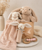 Three plush bunny toys and a baby blanket in a basket on a light surface. Luxury Bunny Baby Gift Hamper | Newborn Girl Gift Basket Australia