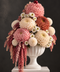Napoletana Sundae luxury flower arrangement featuring pink, cream and caramel chrysanthemums with cascading pink botanicals in a white pedestal vase.