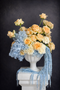 This sculptural bouquet features premium champagne roses in warm, buttery tones, delicately layered with voluminous blue hydrangea to create a cloud-like softness.