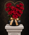 Luxurious Heart shaped red rose arrangement in black bowl with gold ribbon