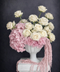 Floral arrangement with white and pink flowers in a vase on a dark background