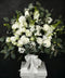 Bouquet of white rose sympathy or funeral flowers with eucalyptus foliage