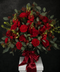 Bouquet of red roses, carnations, orchids and snapdragons with eucalyptus leaves
